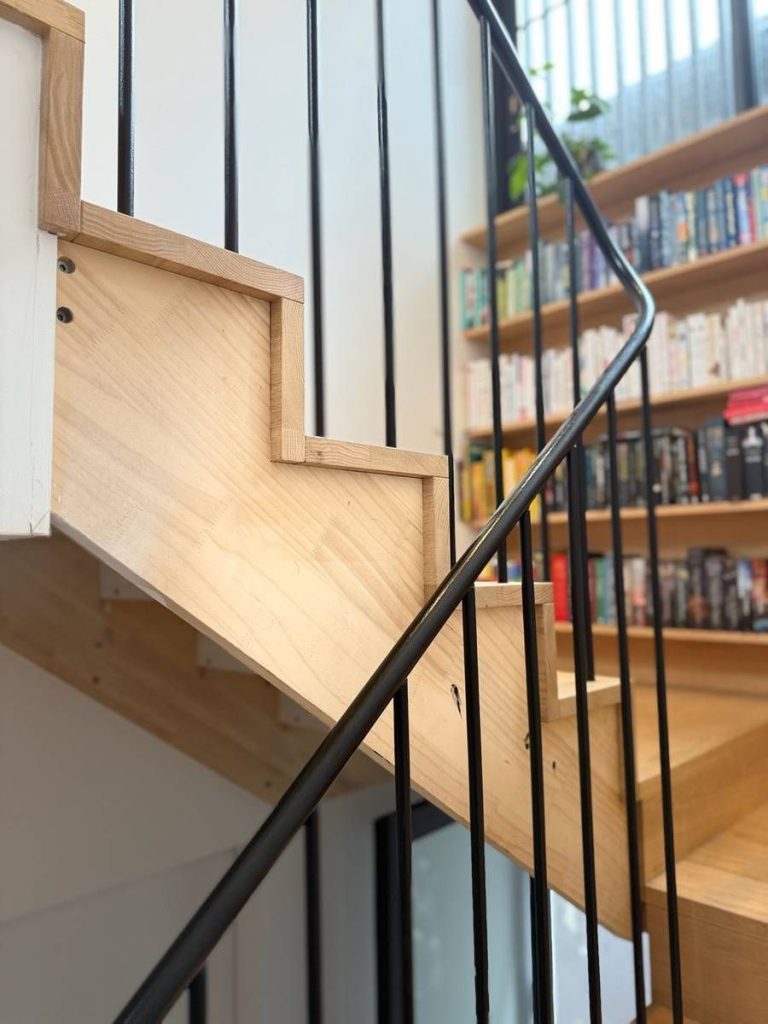 Custom fit-outs and outdoor living: Detail: shelf lines beside the stair